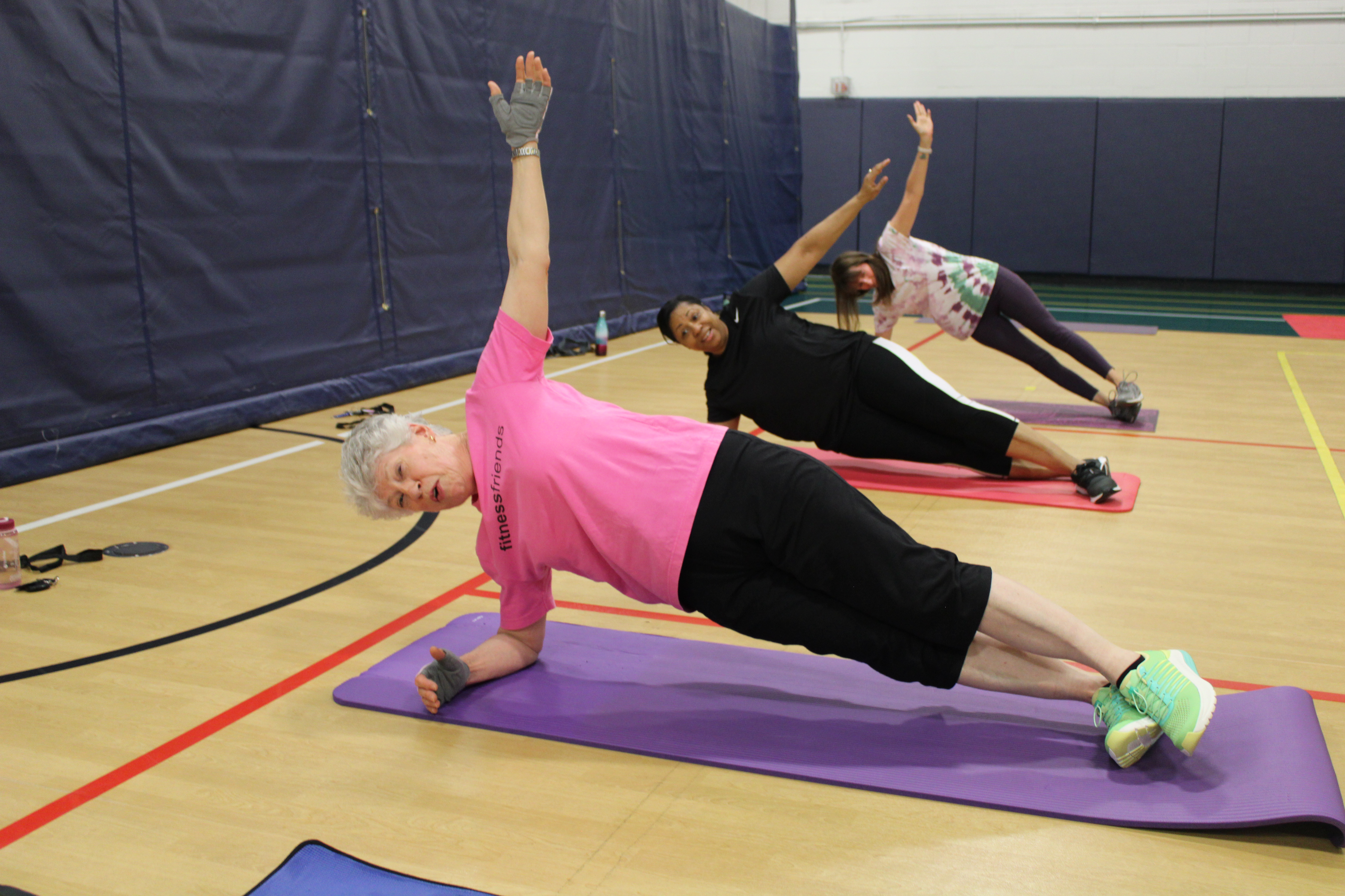 photos of three women doing a side plank exercise 